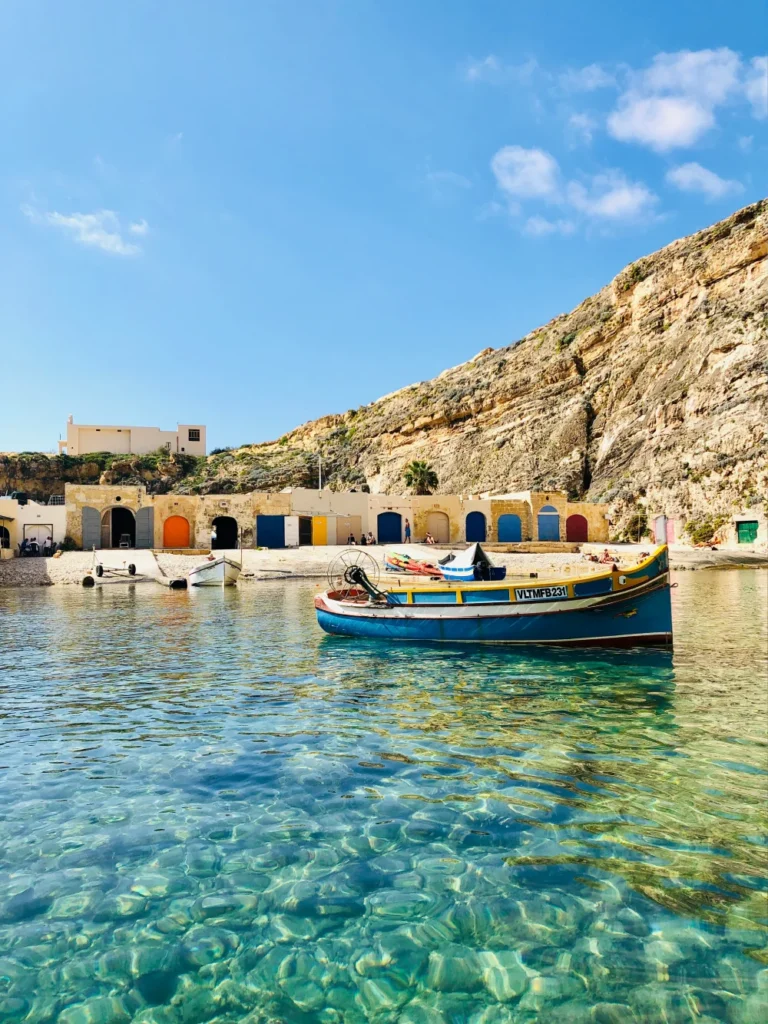 Colorful luzzu fishing boat floating in Marsaxlokk harbor, Malta.
