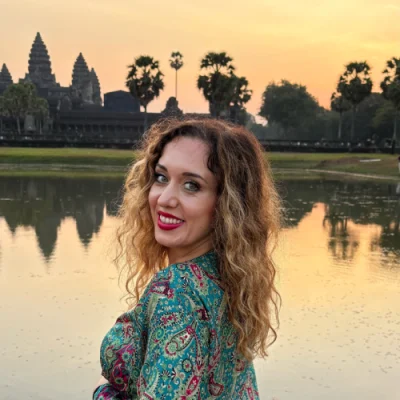 Vesna Karalić smiling at sunset in front of Angkor Wat temple